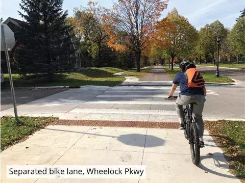 separated bike lane, Wheelock Parkway showing biker separated from traffic and sidewalk space
