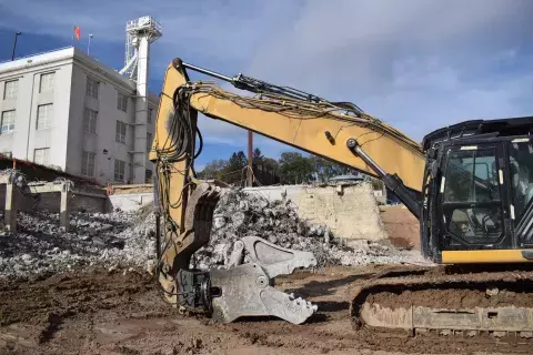 Heavy equipment in front of debris from demolition of McCarrons treatment plant