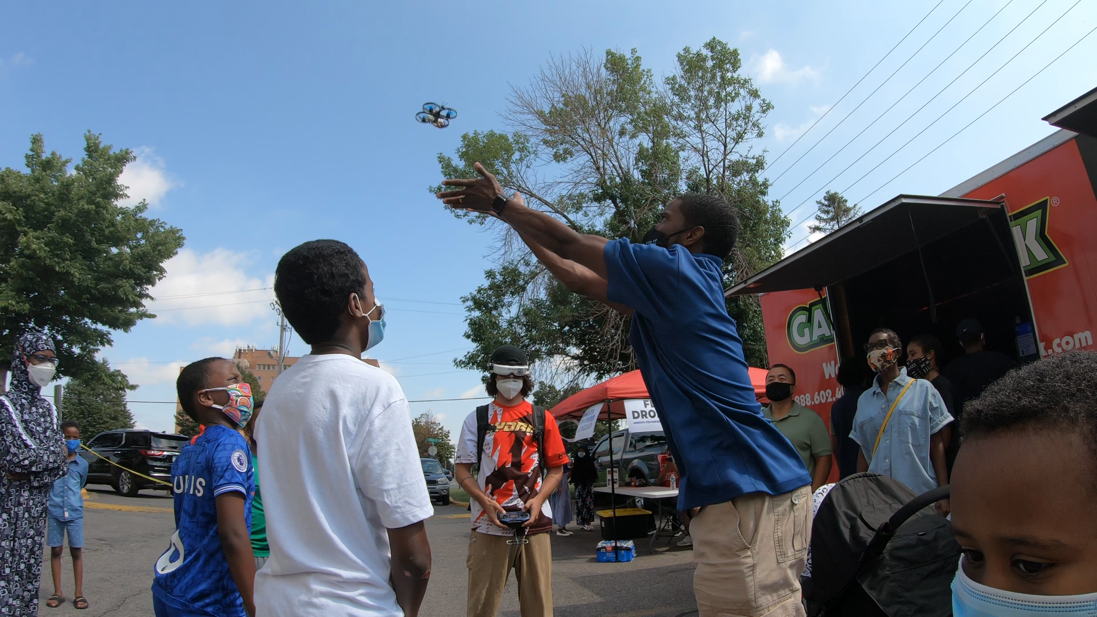 Mayor Carter launches a drone with students