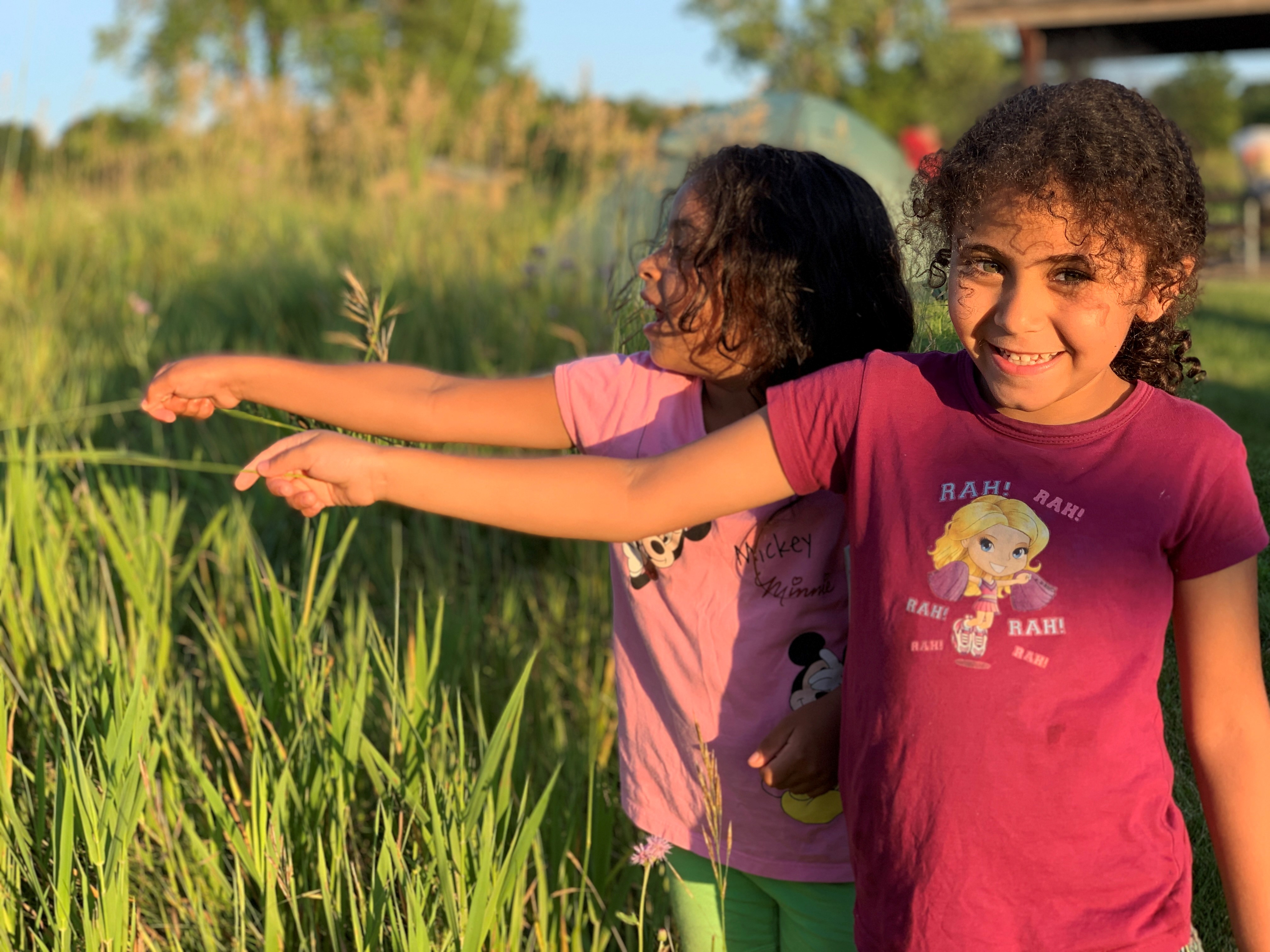 Two young girls in a green field