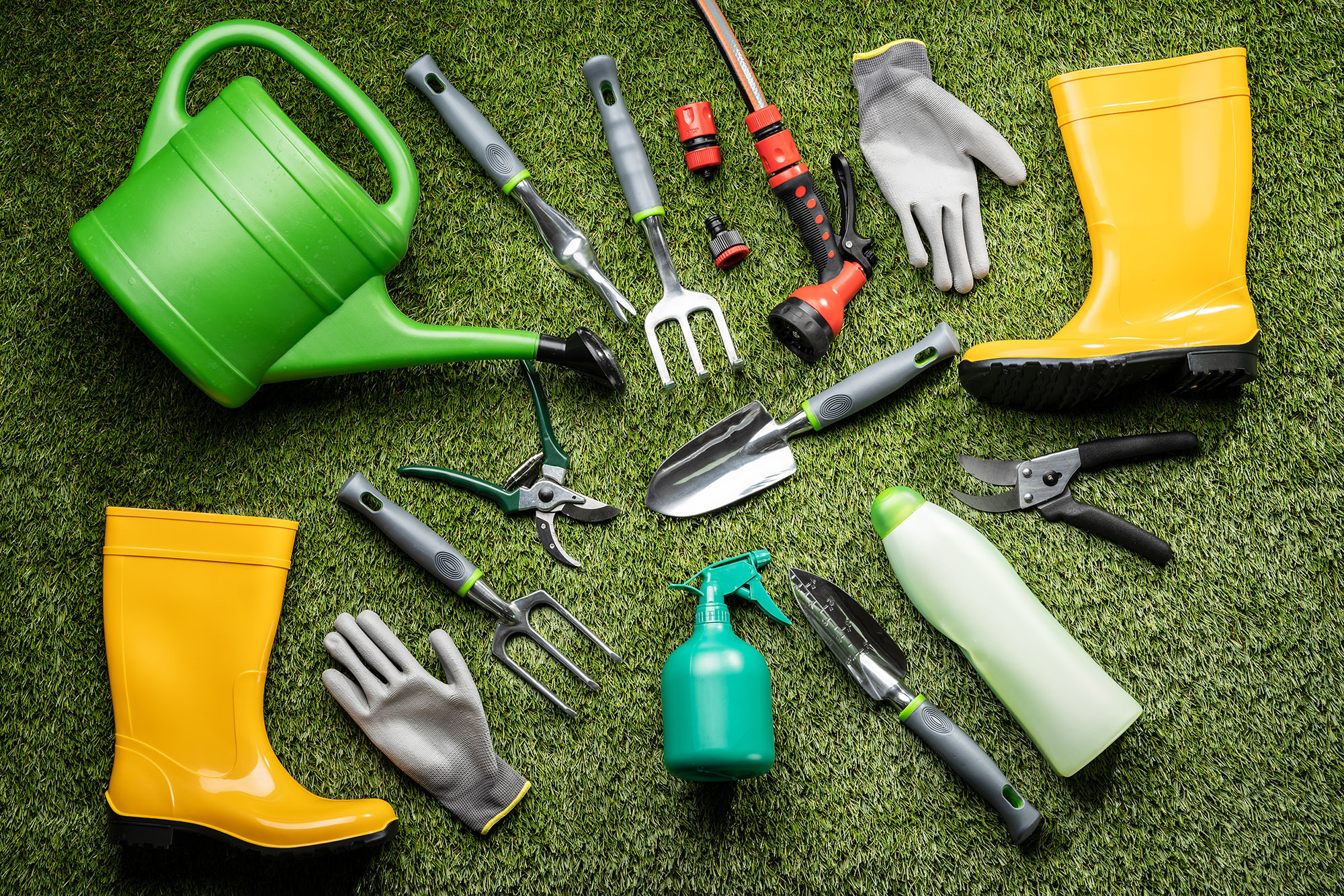 Various garden tools strewn on green turf