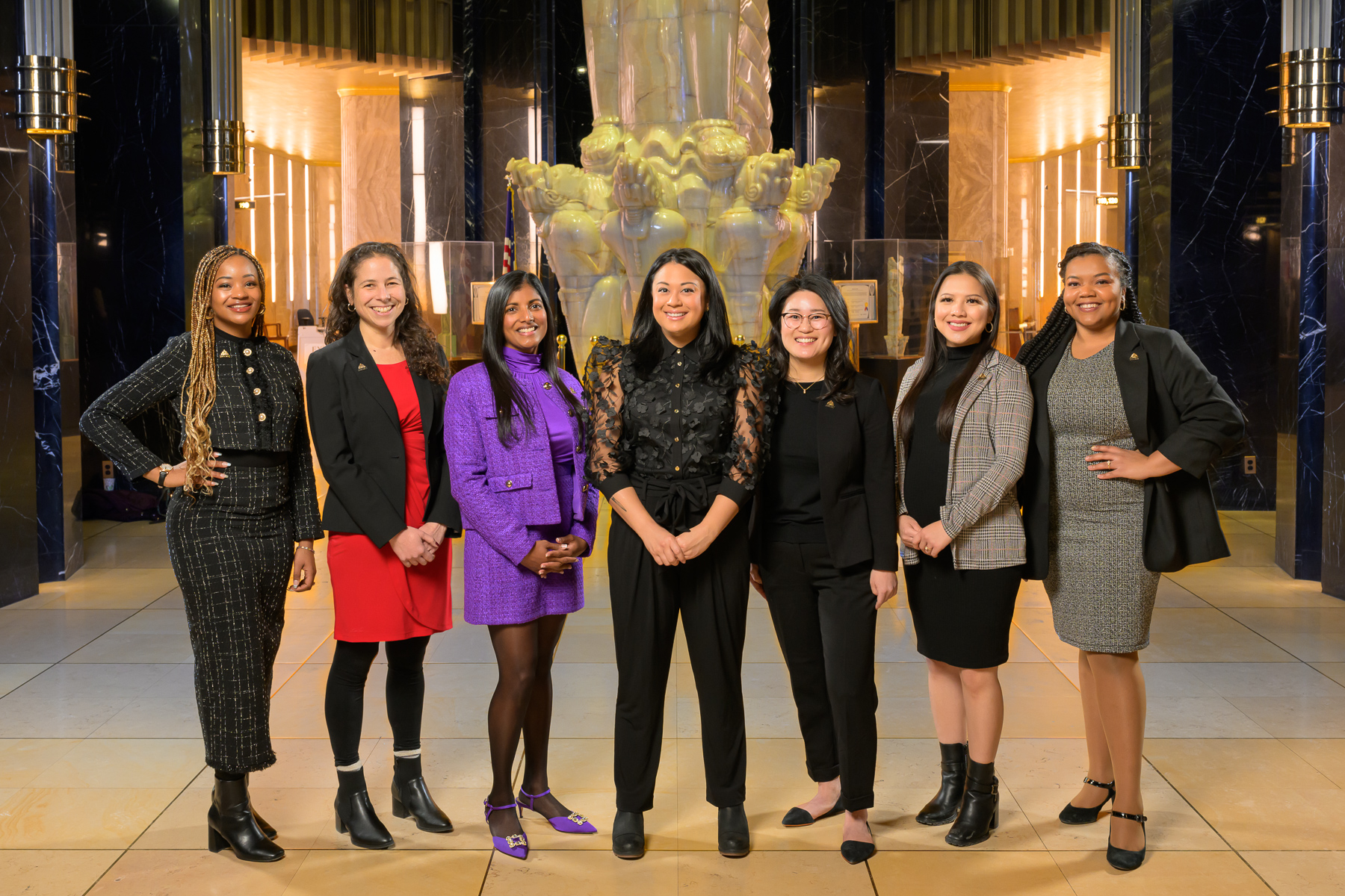 The 2024 Saint Paul City Council stands for a photo in the atrium of City Hall. From left, in order of ward 1 through 7: Anika Bowie, Rebecca Noecker, Saura Jost, Mitra Jalali, HwaJeong Kim, Nelsie Yang, and Cheniqua Johnson. Photo credit: Rich Ryan.