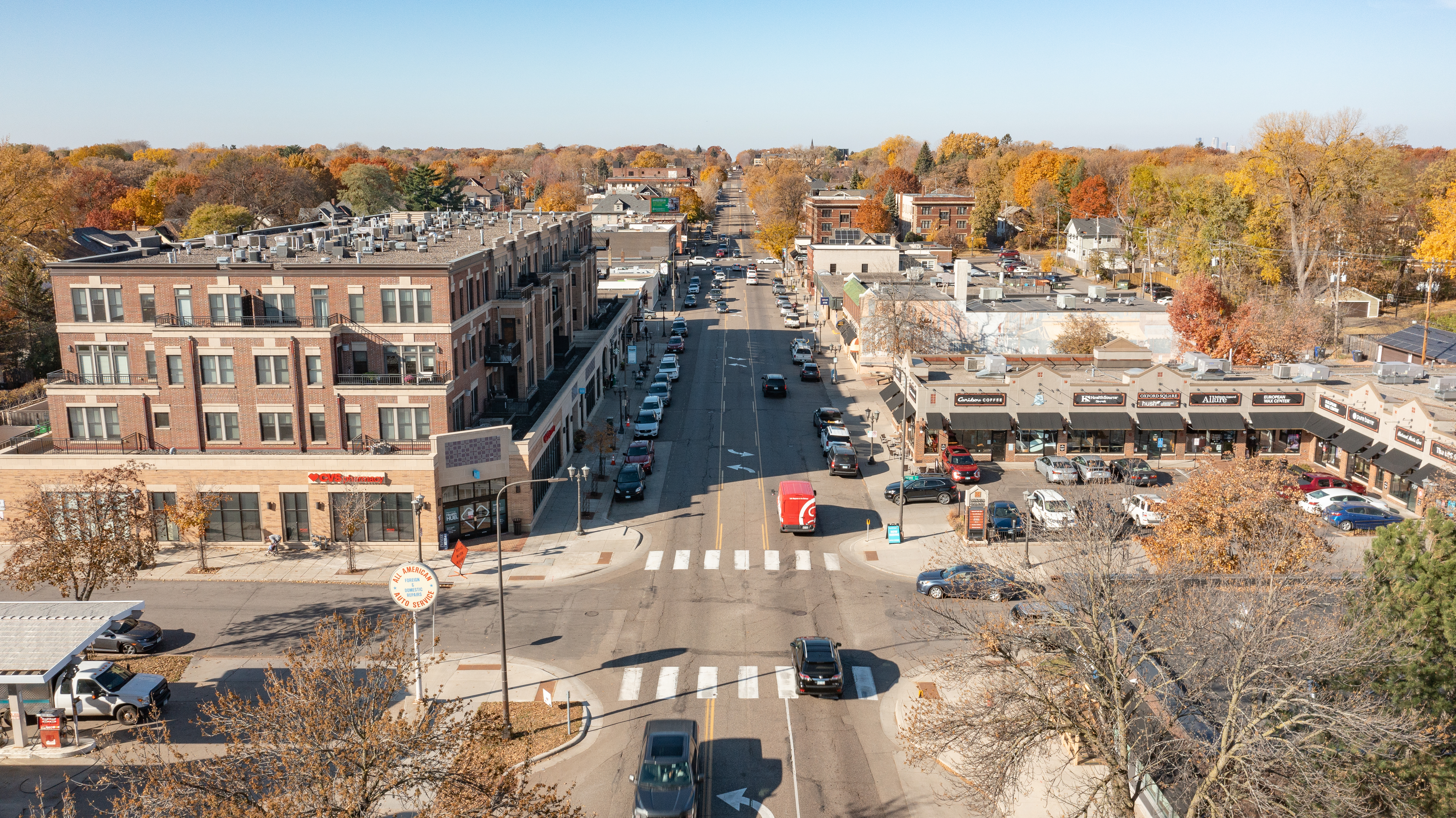 a photo captured by a drone of Grand Avenue, featuring multiple businesses within the shot