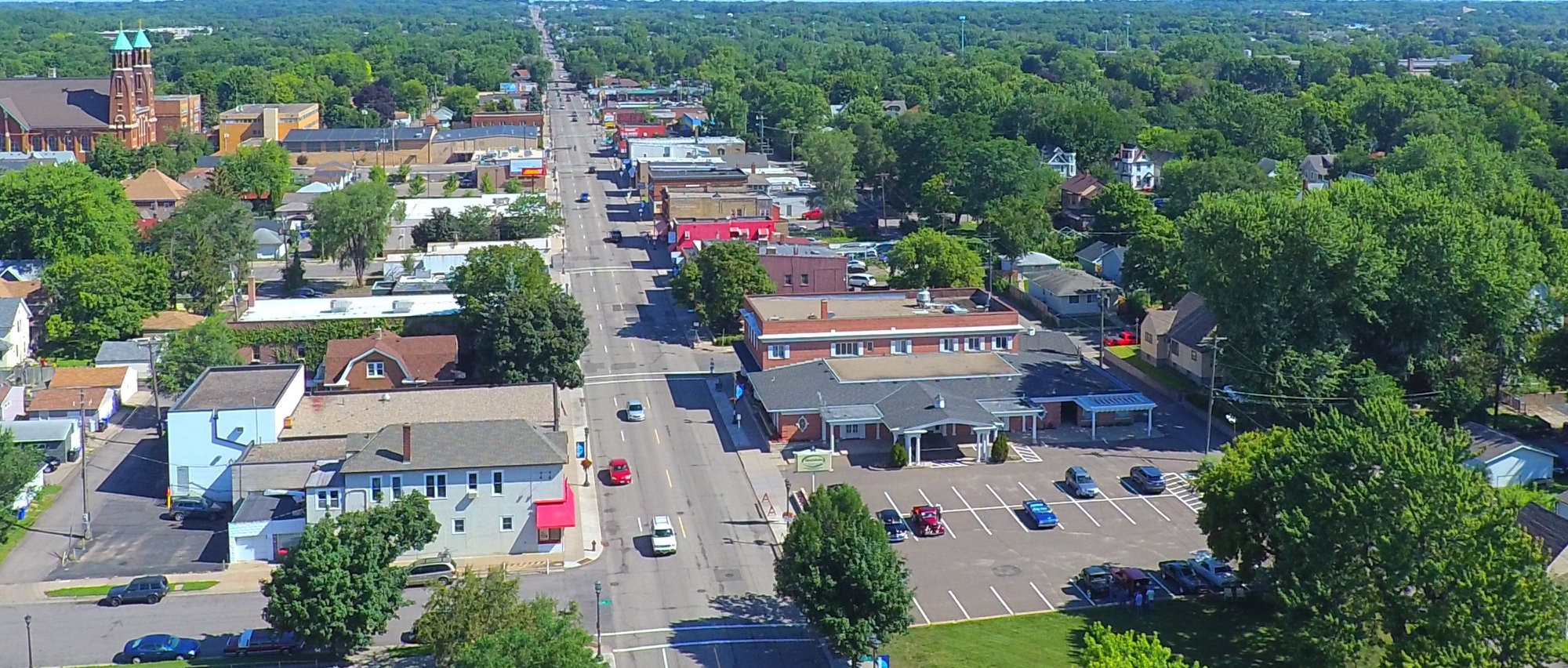 An aerial view of Rice Street. Small buildings and cars can be seen in the shot.