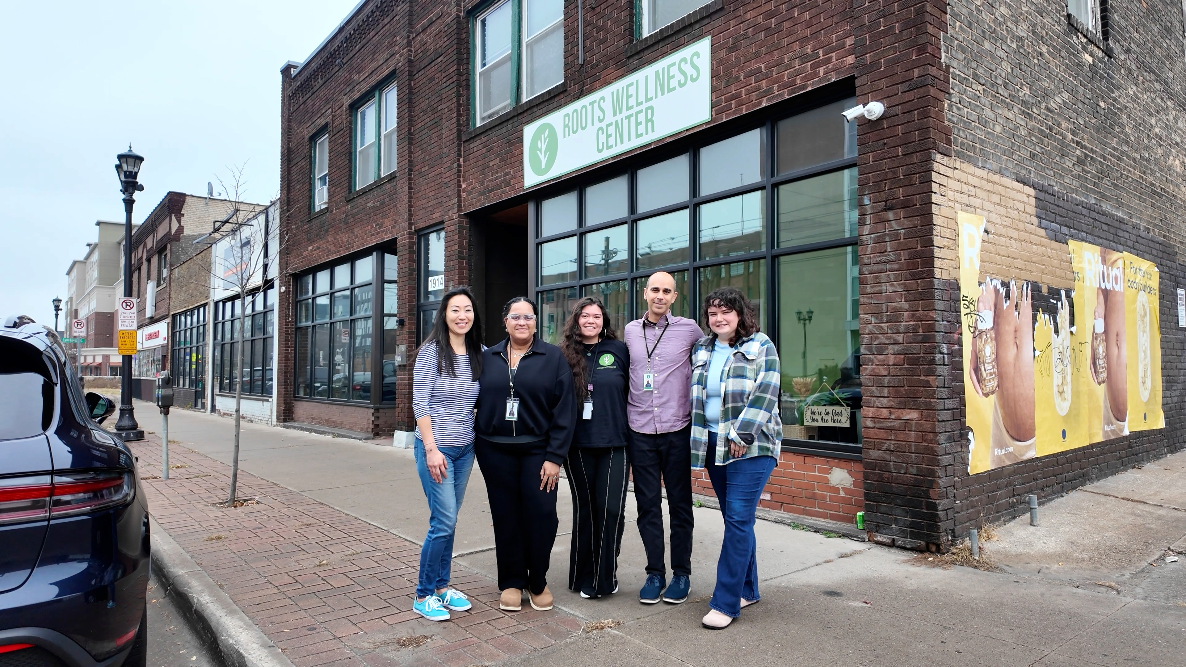 local business owners standing outside of their storefront