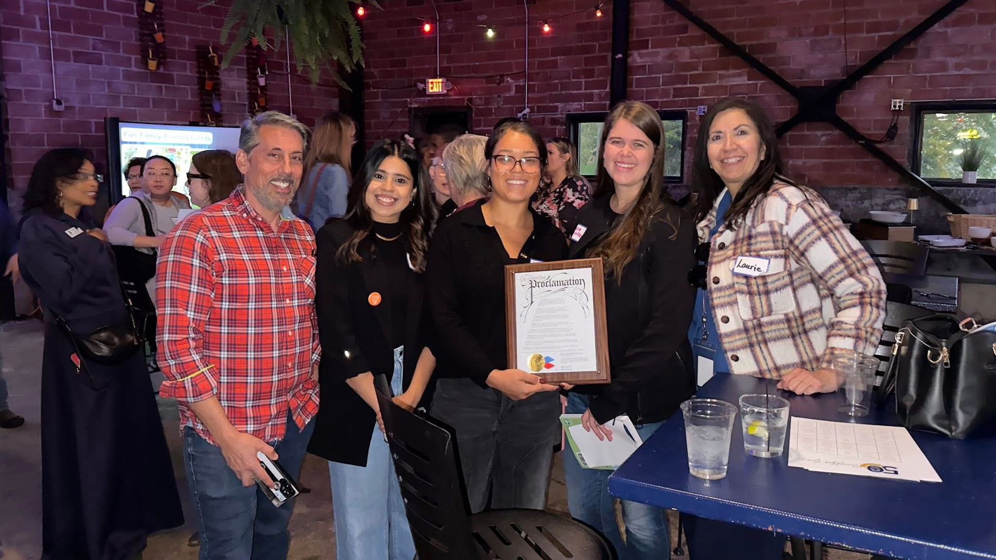District Council members and city staff pose with 50th anniversary proclamation