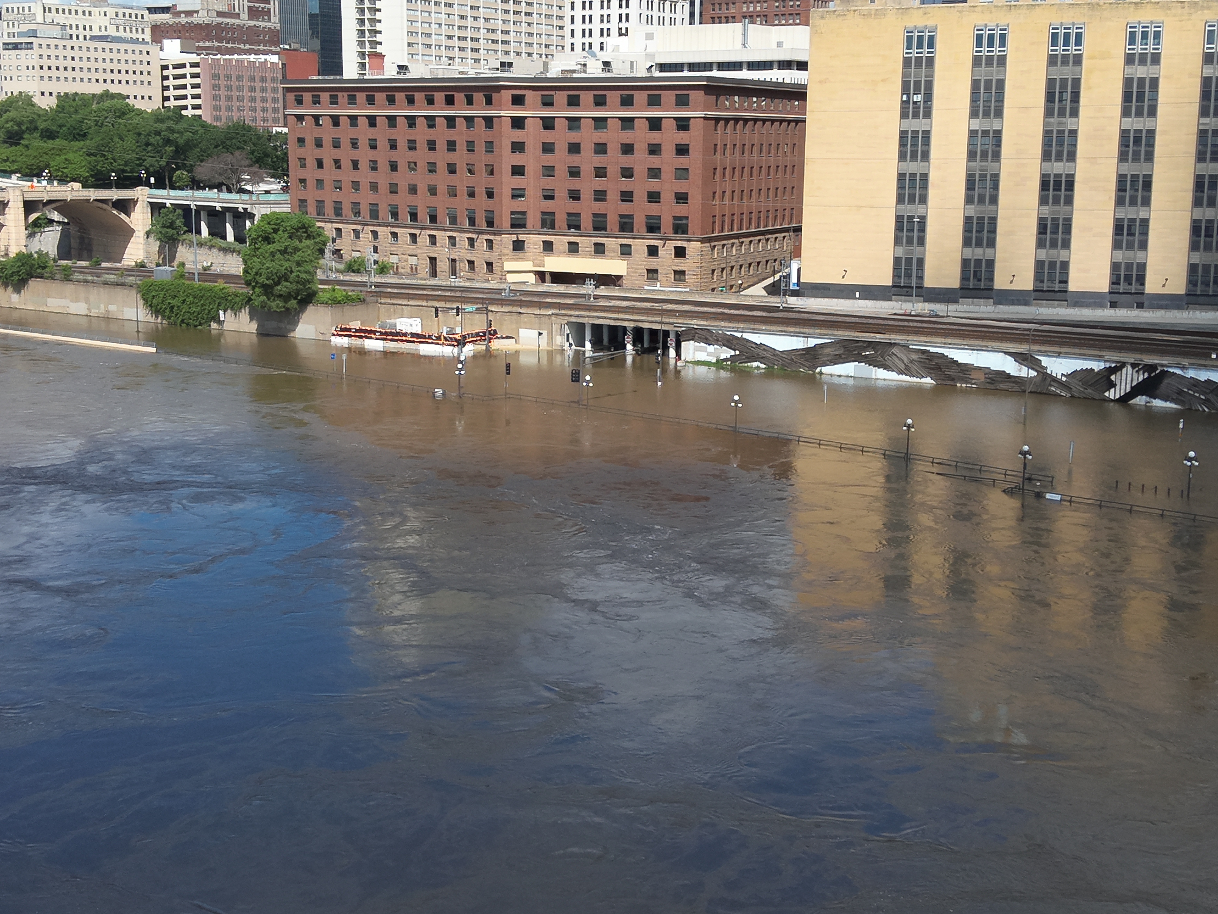 Photo showing Mississippi River flooding in 2024 with Saint Paul Lowertown in background