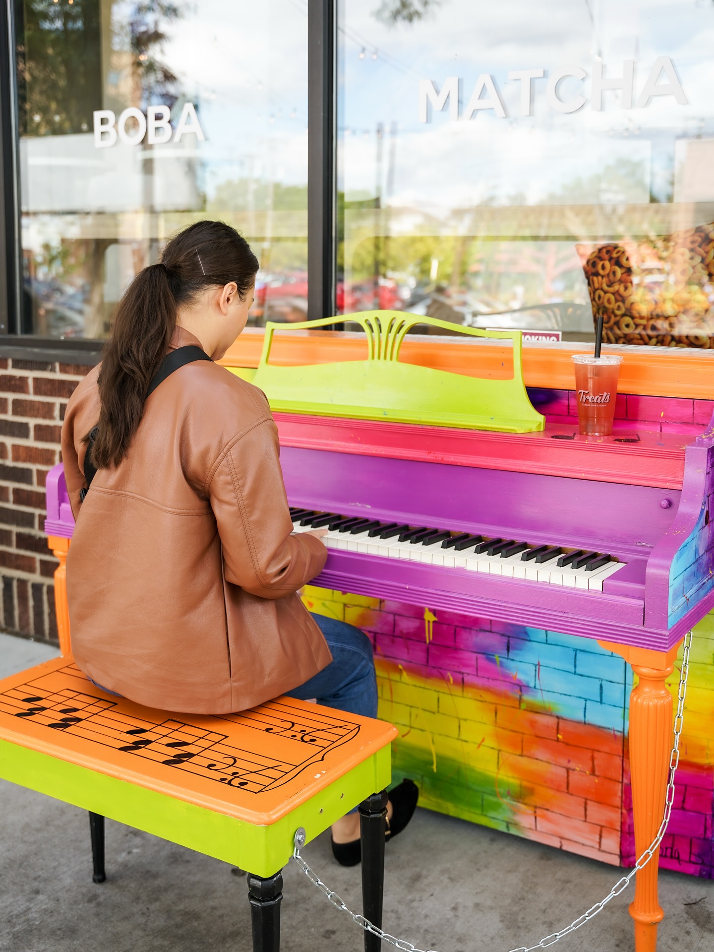 A person playing on a piano along Grand Avenue