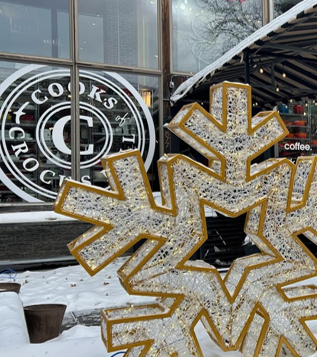 Grand Avenue holiday decorations, an image of a large snowflake decoration next to a business front