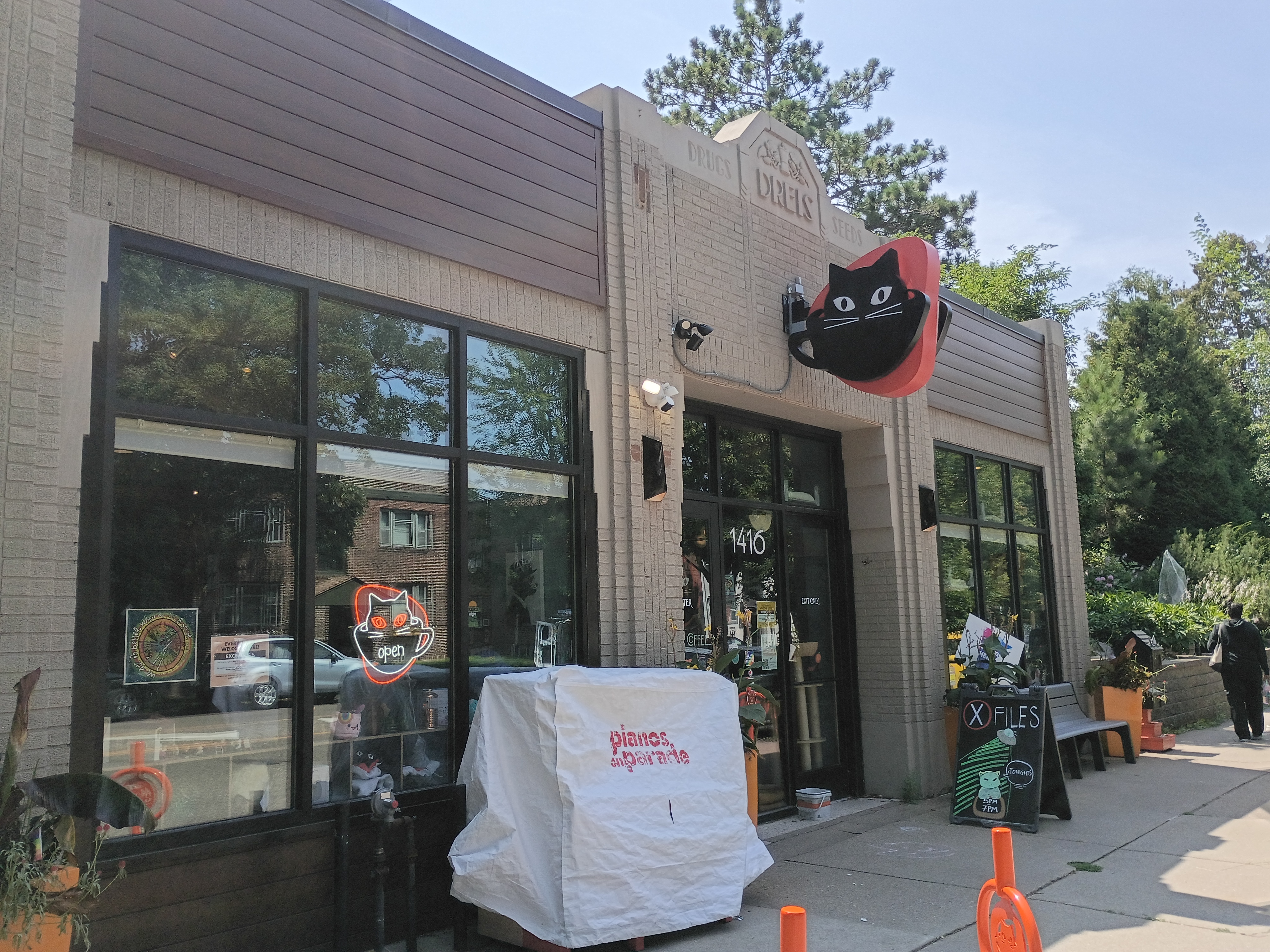 Café storefront at 1416 with a black cat-in-a-cup sign.