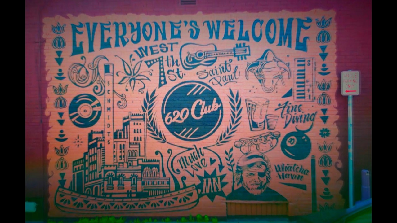 Finished 620 Club mural on West 7th Street reading "Everyone's Welcome," with vintage-style illustrations celebrating the bar and Saint Paul.