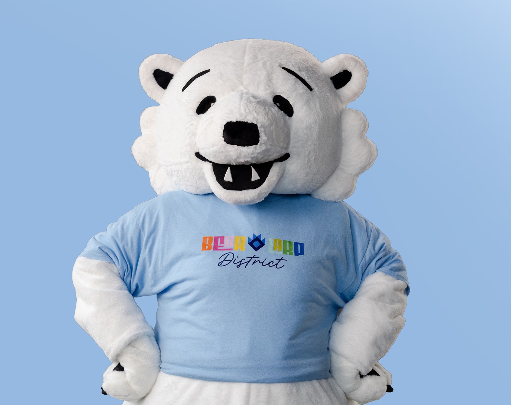 Matoskah, the Bear + Larp District polar bear mascot, poses in a district T-shirt.