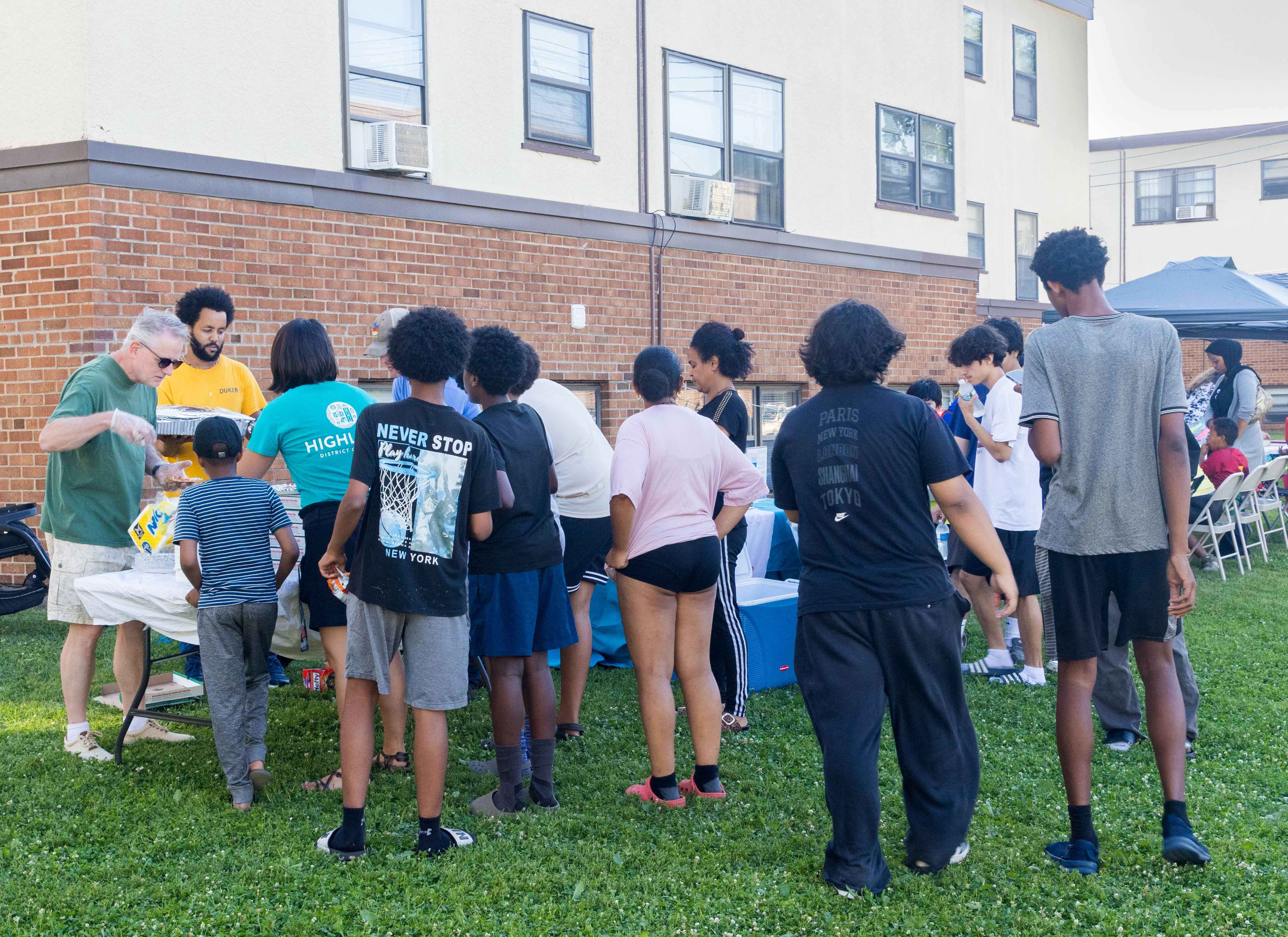 Residents gather for food at a Highland District Council community event on the lawn at Sibley Manor.