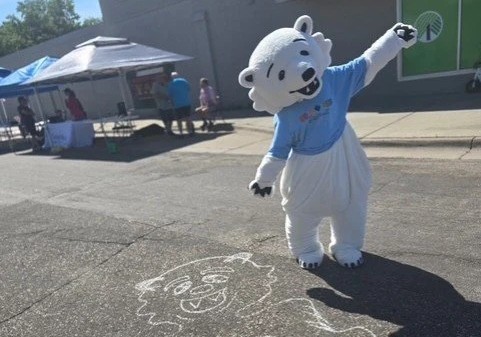 Matoskah poses beside a chalk drawing of himself at Matty's Chalk Festival.