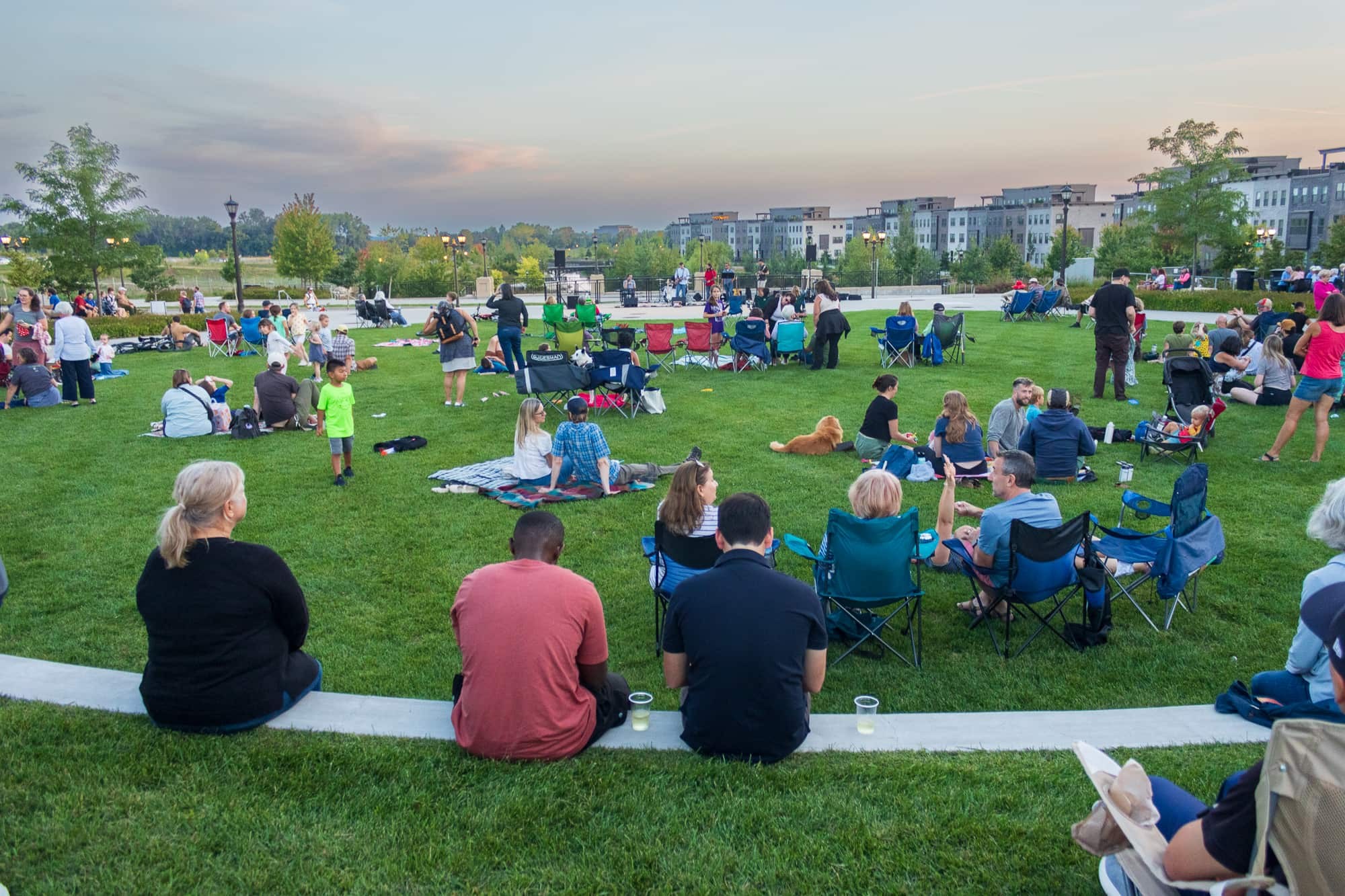Crowd seated on the lawn at a Music at the Bridge concert