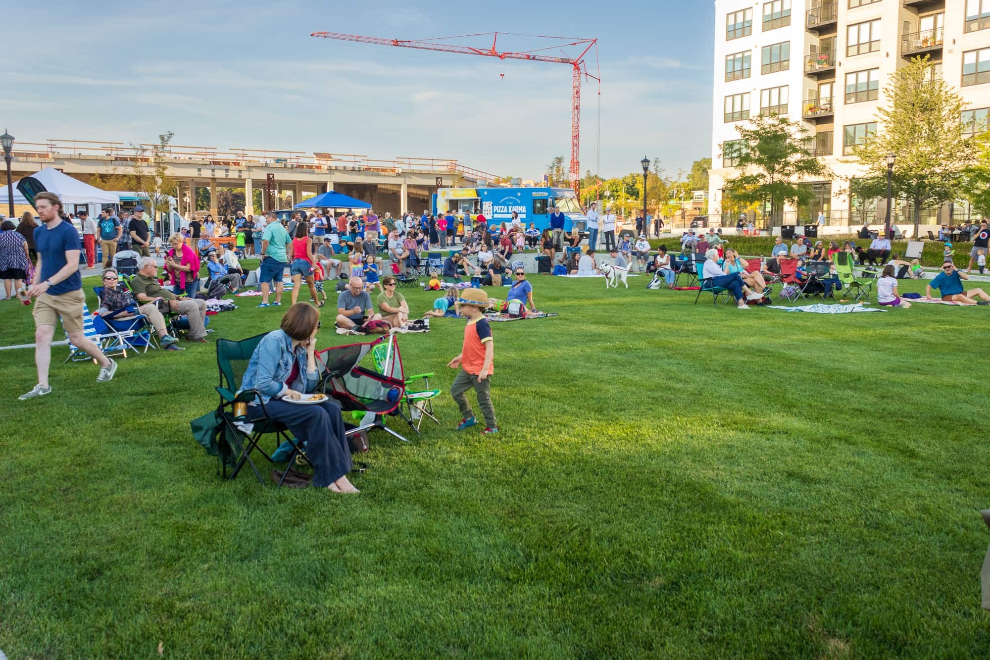 Crowd seated on the lawn at a Music at the Bridge concert