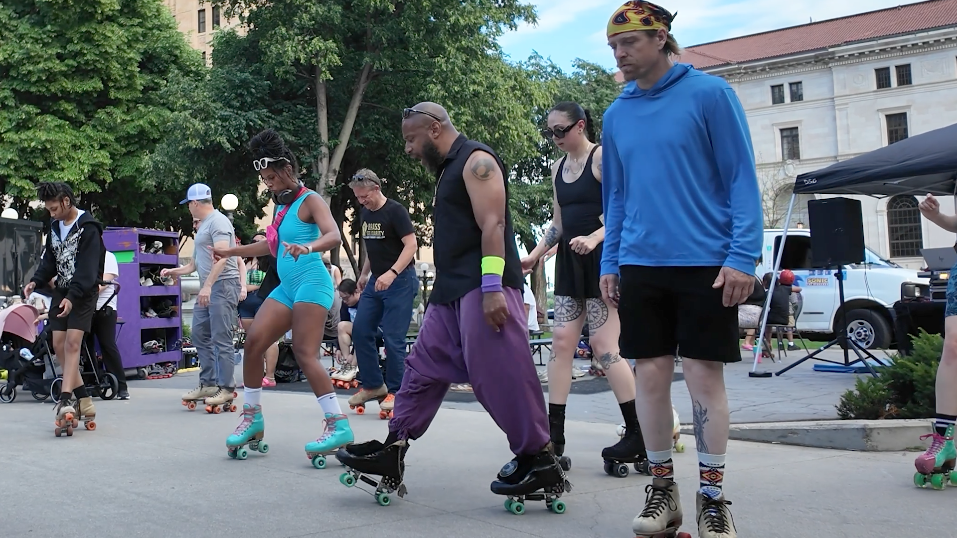 People roller skate around the fountain at Rice Park in downtown.