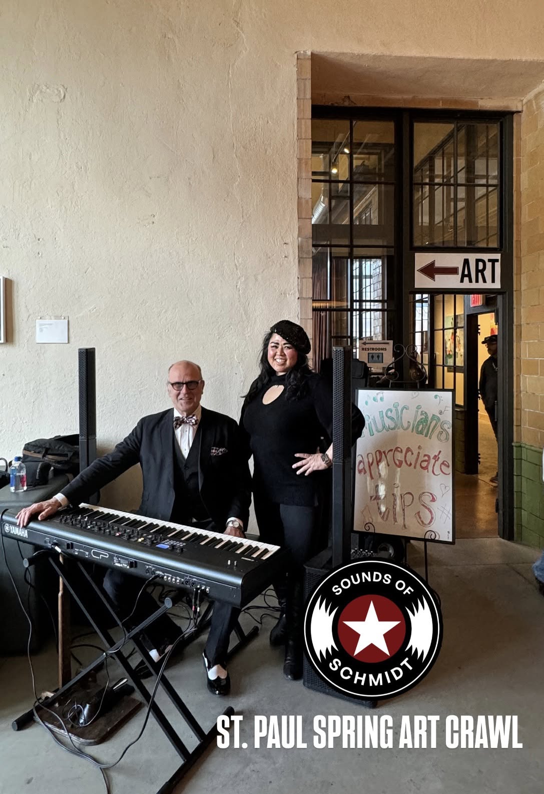 Two musicians pose with a keyboard at a Sounds of Schmidt performance during the St. Paul Spring Art Crawl.