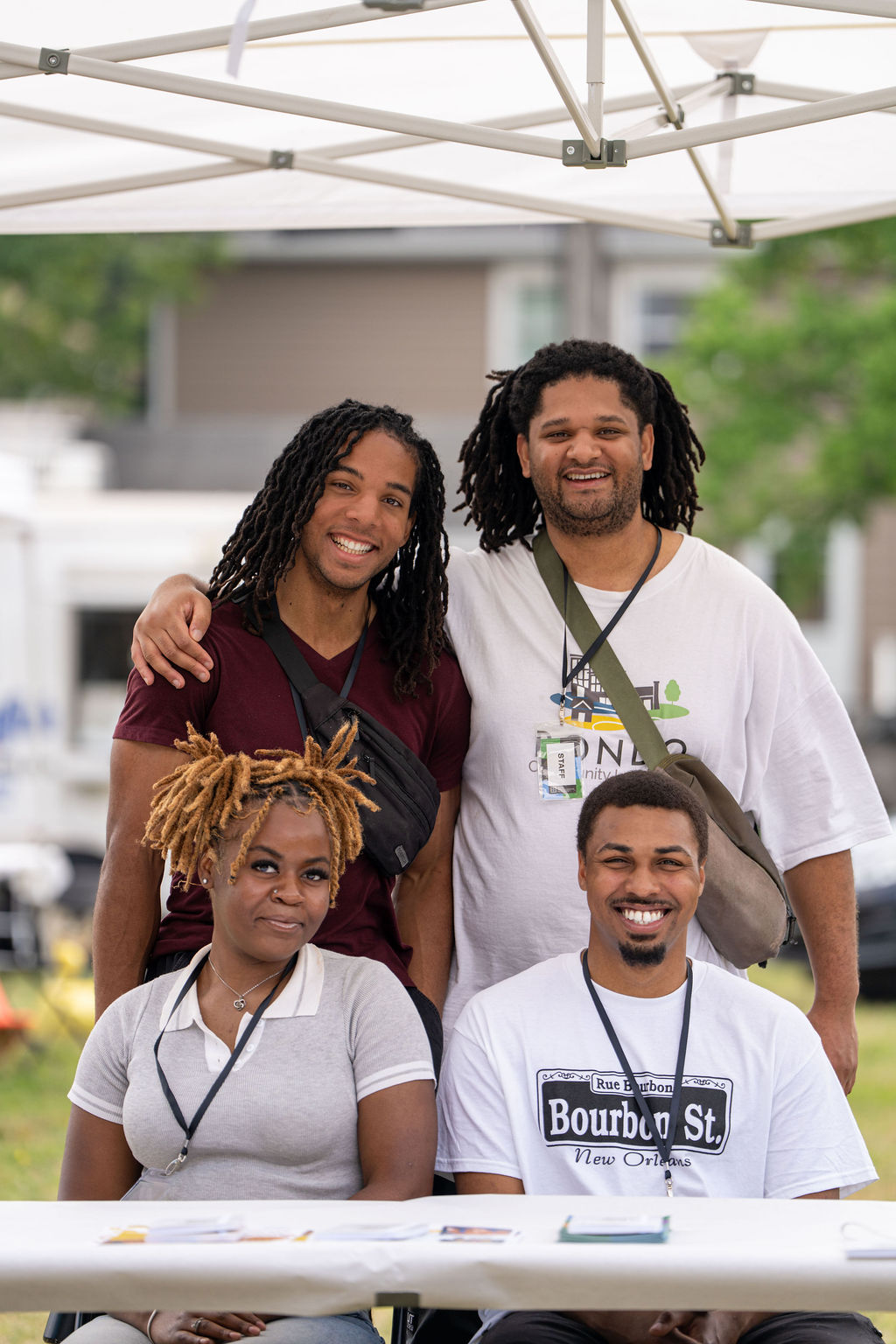 Four Rondo Community Land Trust staff members pose together at an outreach tent.