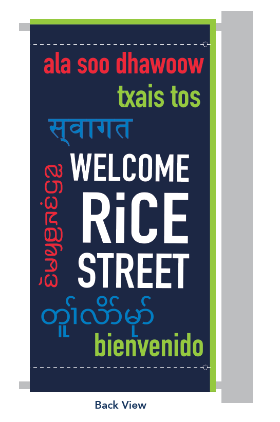"Welcome / Rice Street" pole banner with welcome messages in seven languages, back view.