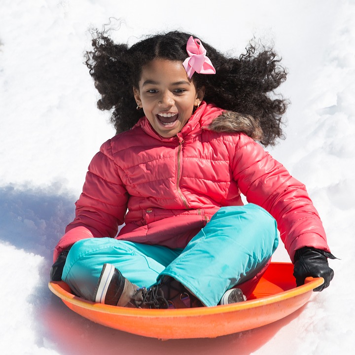 child on sled saucer