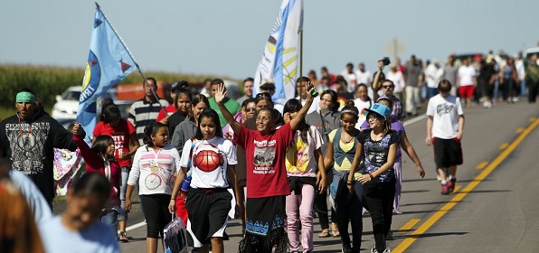 Dakota people crossing the border from South Dakota to mark the 150th anniversary of their exile from Minnesota.