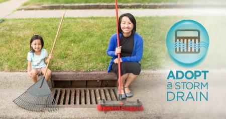 Image of people sitting near a cleaned out storm sewer drain