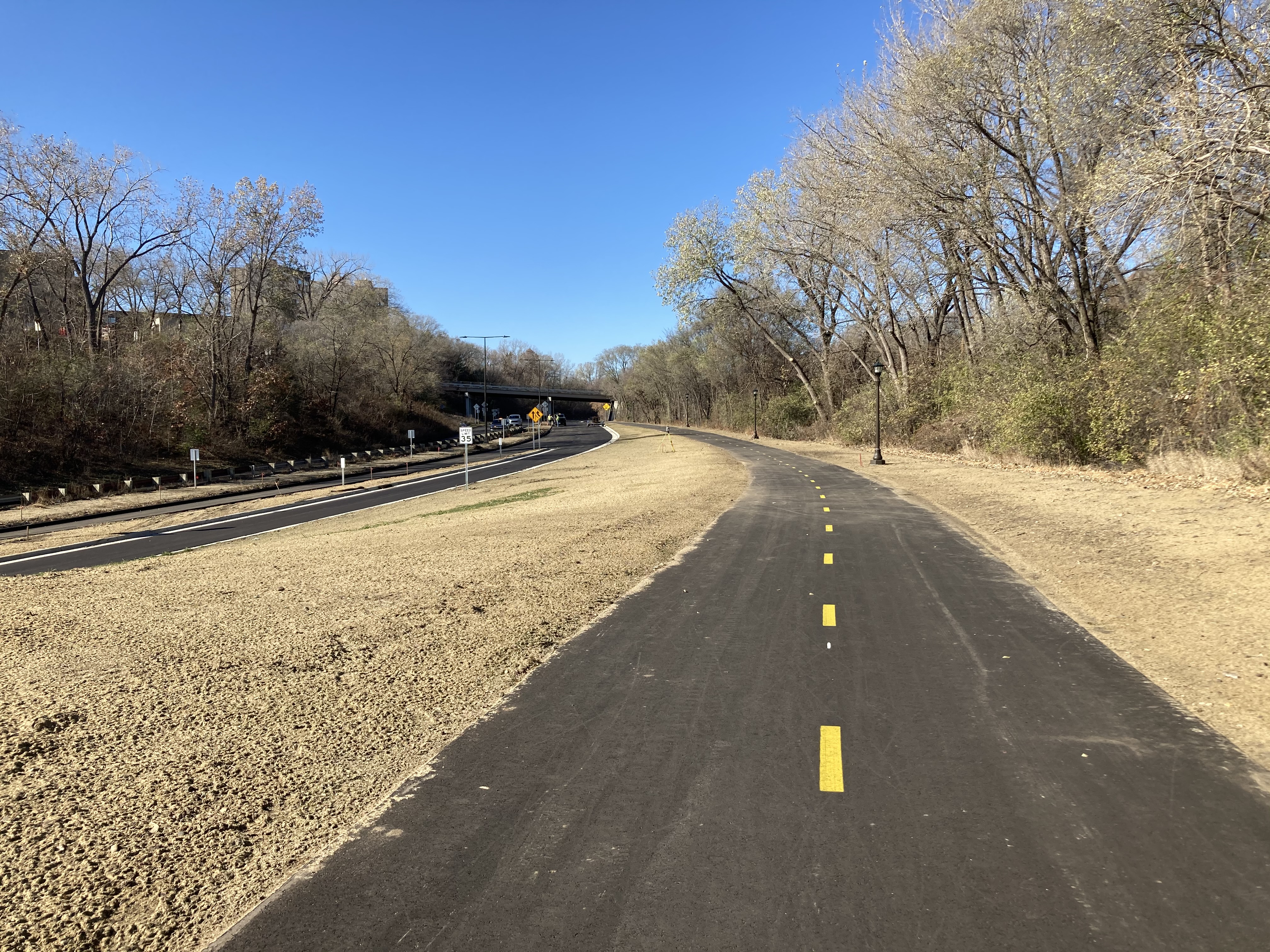 Photo of newly constructed bike and pedestrian trail along the east side of Ayd Mill Road and the newly resurfaced north and south bound vehicle lanes.