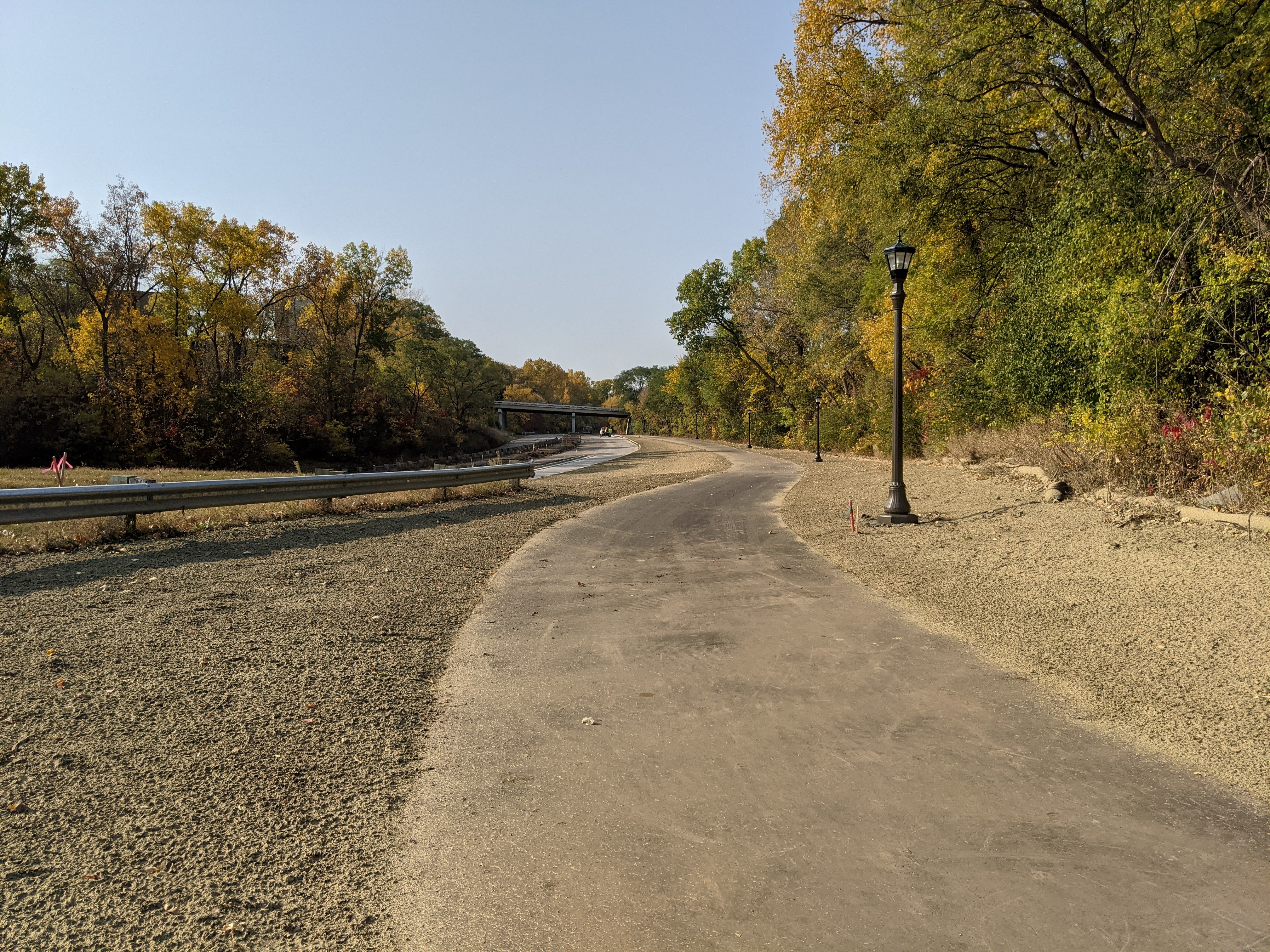 Photo of Ayd Mill Road construction as of 10.10.20. Photo shows the new light poles along the trail as seen north bound from Jefferson Avenue.