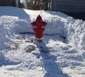 Fire hydrant shown in winter with immediate area cleared of snow. Fire hydrant shown in winter with immediate area cleared of snow.