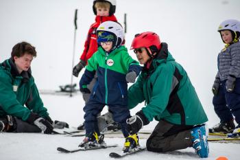 Youth taking ski lessons