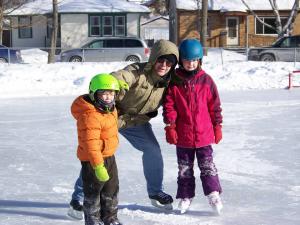 Family skating A family skating on one of our city's many ice rinks