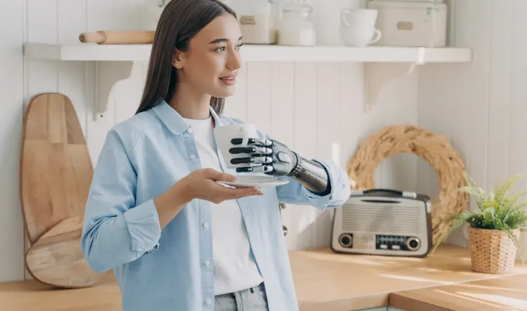 Disabled girl is holding cup with cyber hand. 