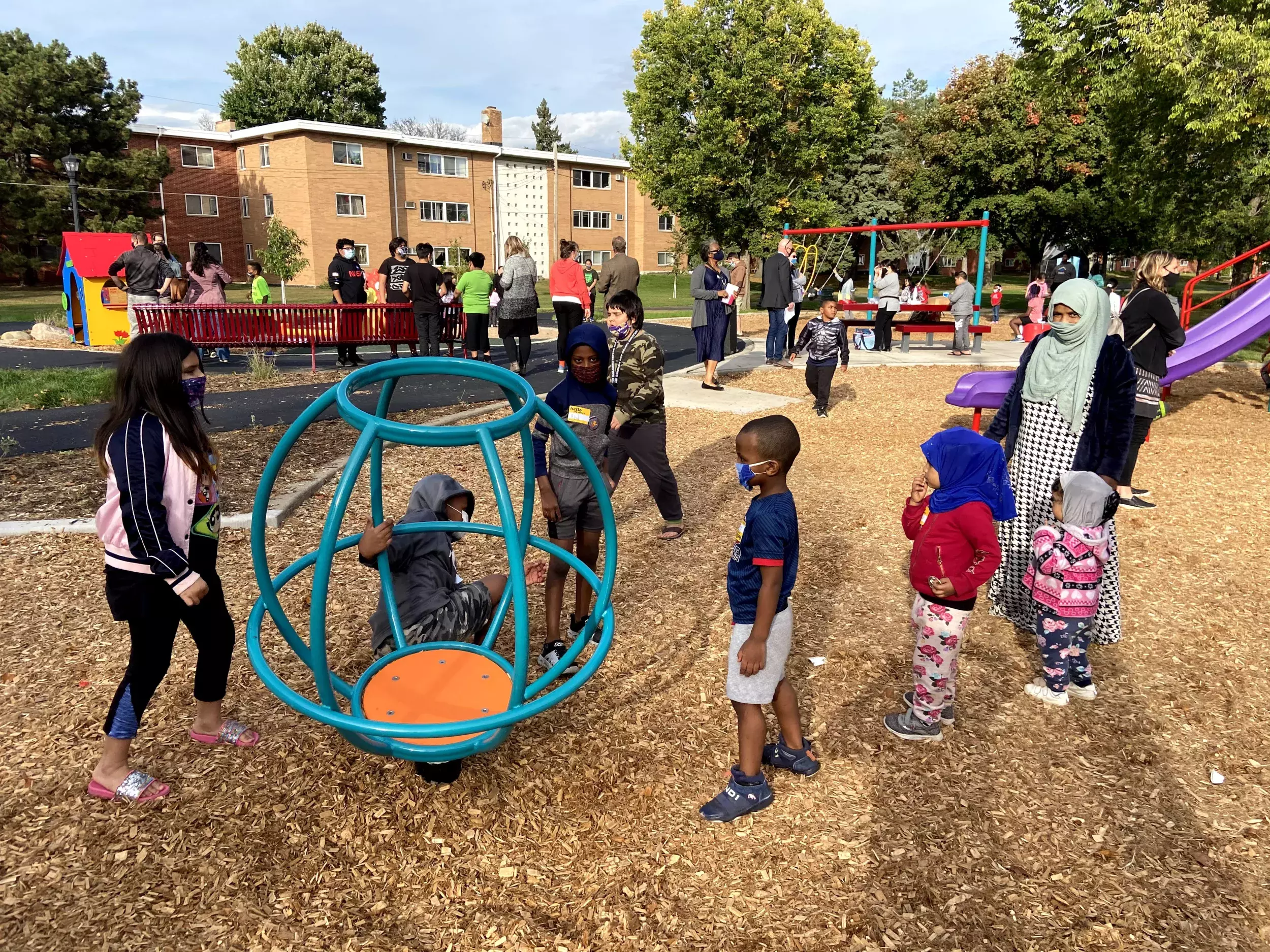 Several families recreate at a playground