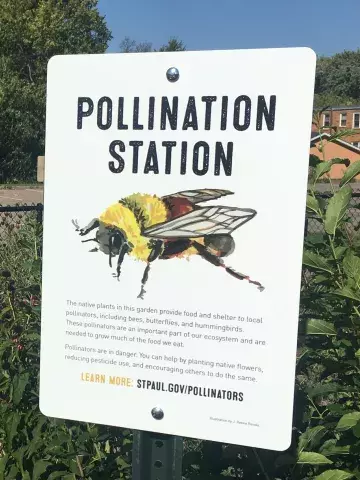 White  sign reads "pollination station" with image of bumblebee
