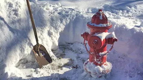 Hydrant and shovel in area where snow has been removed