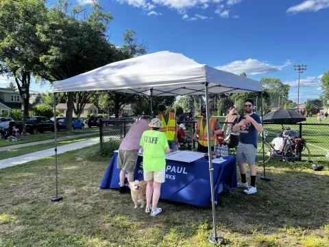 Photo of a July 17 pop up open house on the corner of Park and Rose. City staff and neighbors are pictured at a tent canopy with information. 