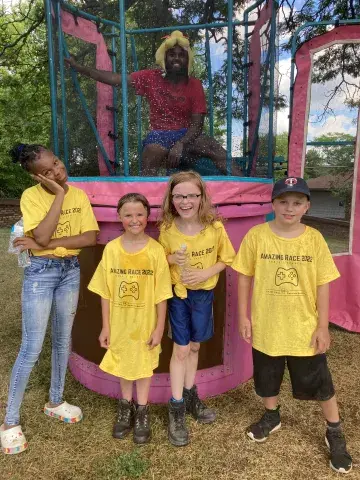 Amazing Race team in front of dunk tank_Lake Phalen