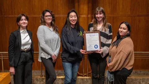 Roots Wellness Center holds their business award certificate