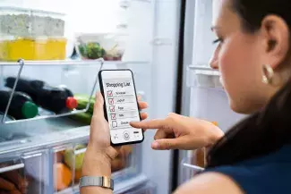 Shop the Fridge First Woman Shopping Fridge and making a list