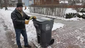 man reading education tag, winter