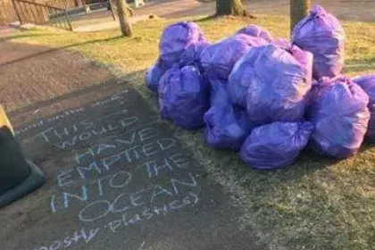 Bags of litter along a trail