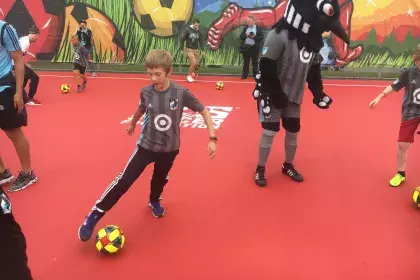 Hamline Park futsal court with youth and loon mascot playing futsal