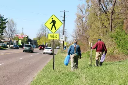 two men picking up litter