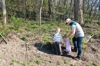 a man and boy picking up litter