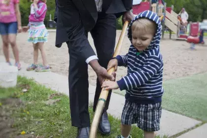 Mayor Carter and young child planting on Arbor Day