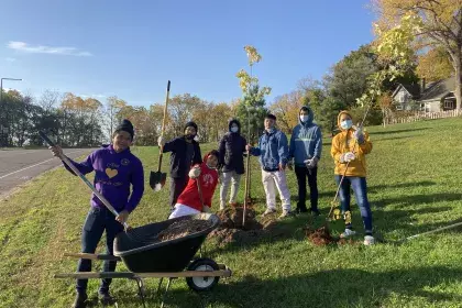Group planting a tree on Arbor Day