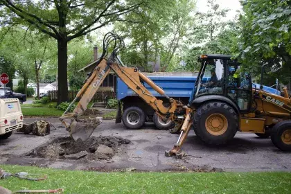 SPRWS heavy construction equipment digging a hole in a street