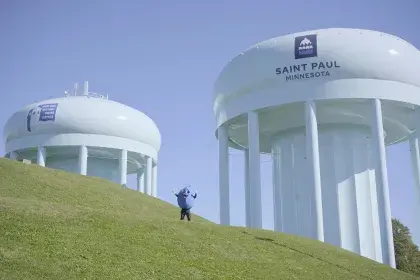 SPRWS mascot Willy Water poses next to Highland Tower 2 & Highland Tower 3