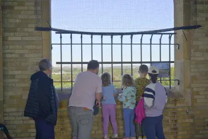 Six Highland Water Tower visitors soak in the view from the observation deck